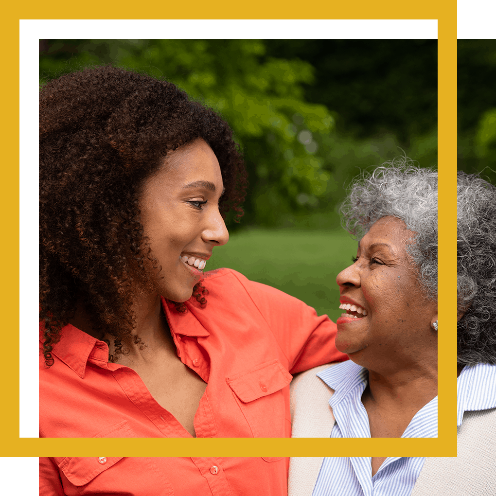 two women looking and smiling at one another