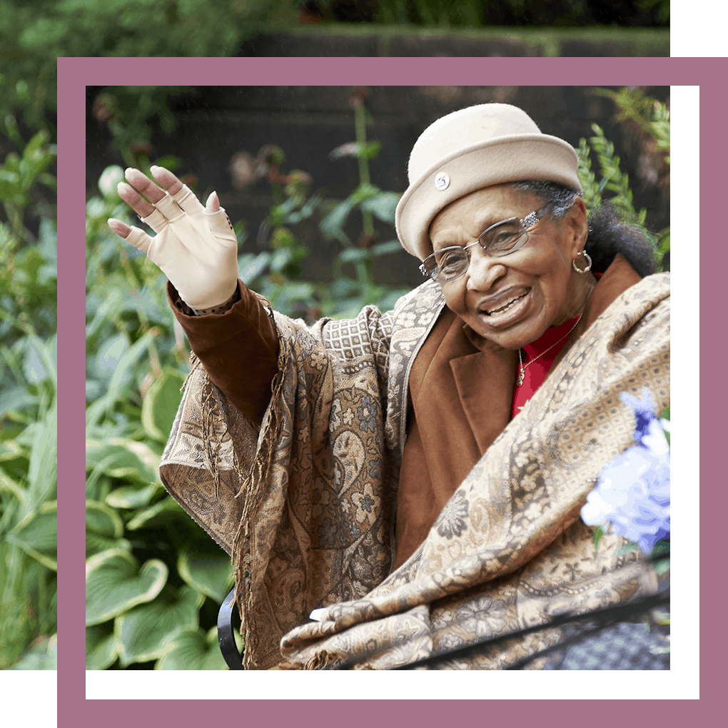 resident at Luther Manor waving