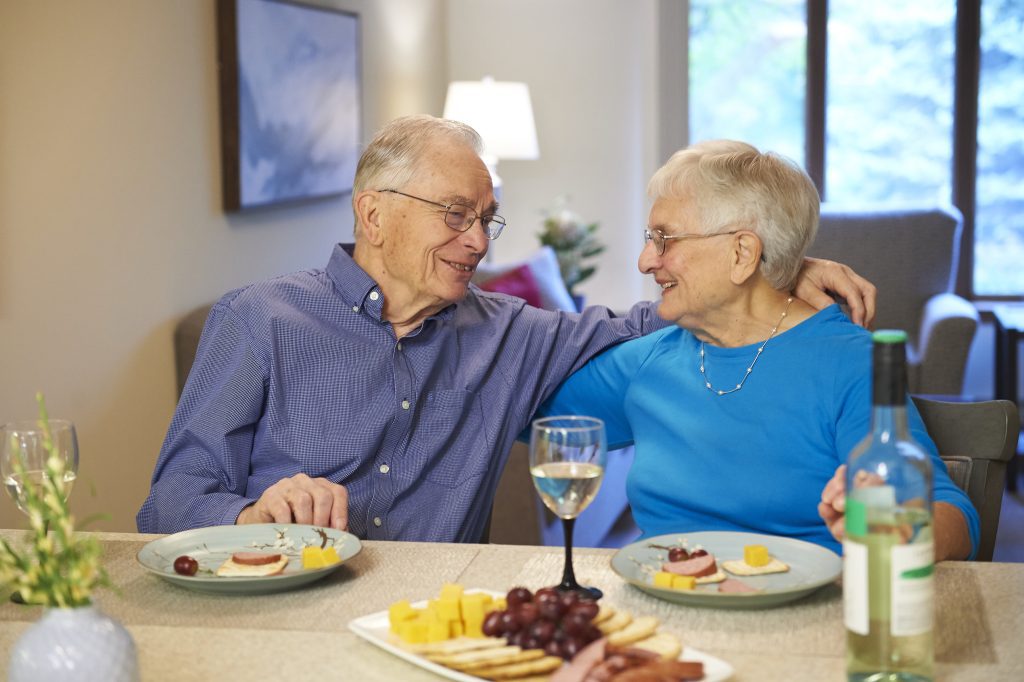 our residents enjoying a dinner in their senior living apartment